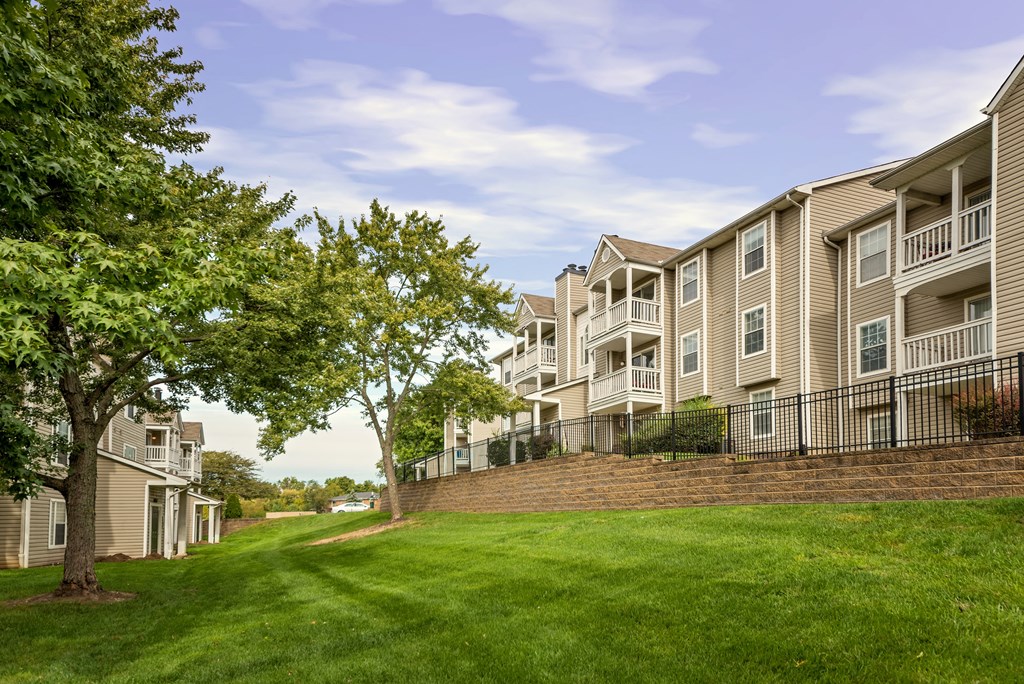 Exterior view of tan apartment buildings at The Boulevard in Florence, KY with private patios and well-maintained landscaping