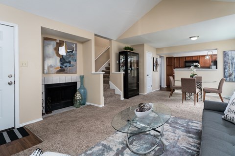 a living room with a fireplace and a glass table