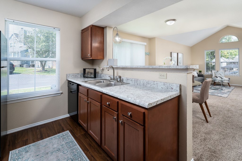 a kitchen with wooden cabinets and granite countertops