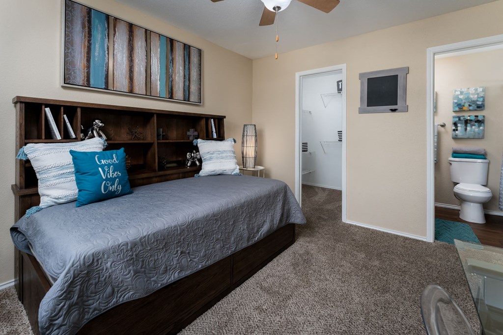 a bedroom with a bed and a ceiling fan