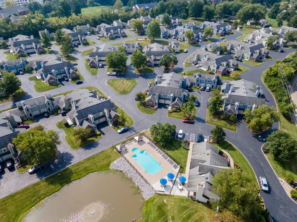 an aerial view of a neighborhood with a swimming pool and parking lot