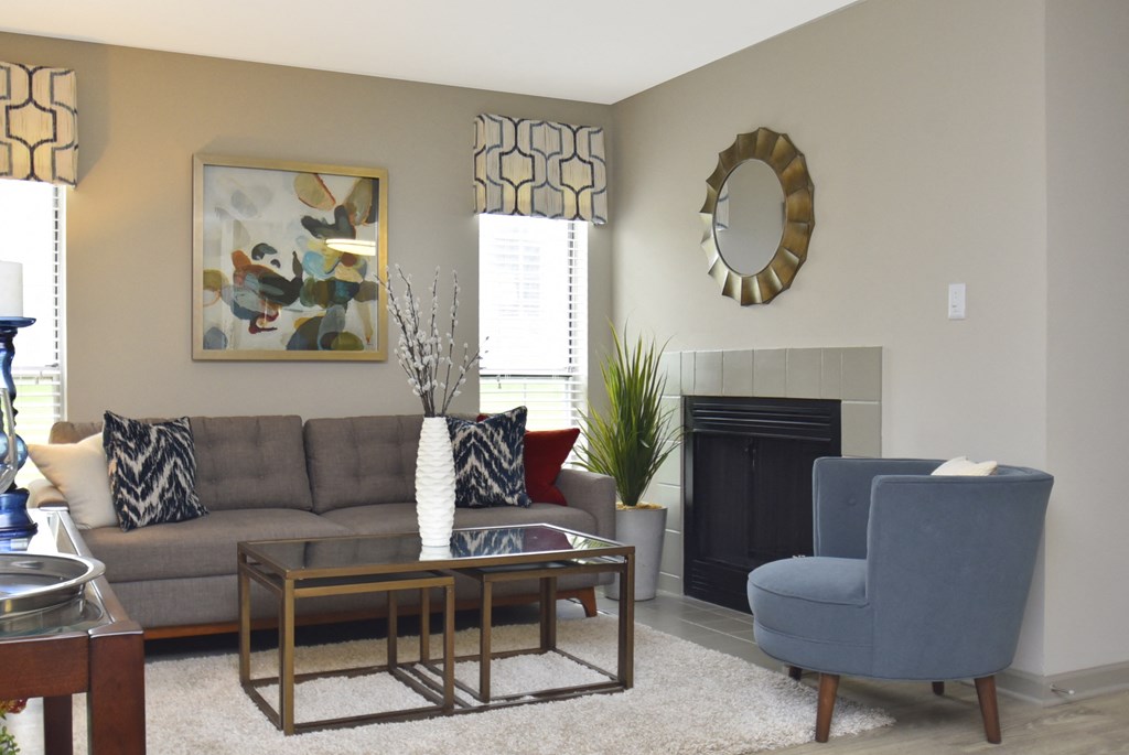 a living room with a couch chair coffee table and fireplace
