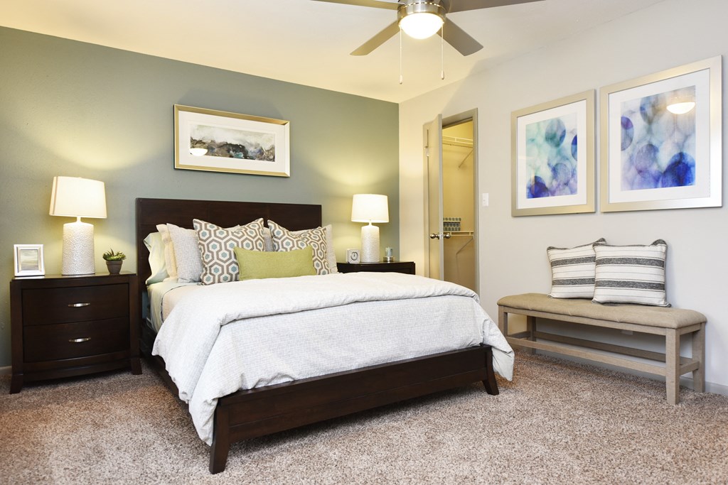 Dog-Friendly Apartments in Fishers, IN - Metropolitan Fishers - Furnished Bedroom with Plush Carpet Flooring and a Ceiling Fan