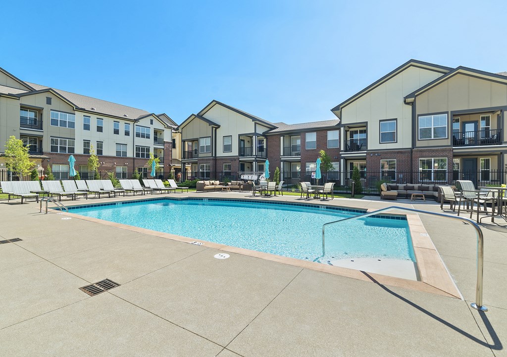 Studios in Miamisburg, OH - Austin Park - Pool with Lounge Chairs, Couch, and Tables.