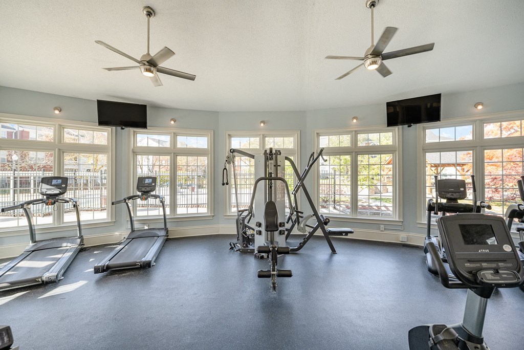 Reserve at Hamburg fitness center with a selection of workout  equipment, large windows, and two TV's.
