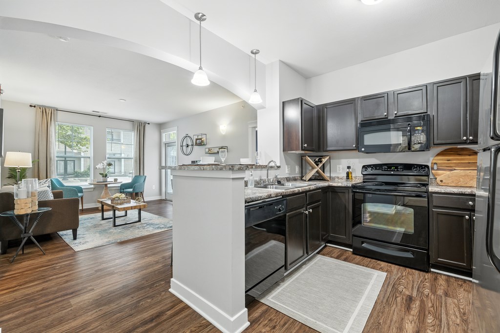 A modern kitchen with dark wood cabinets and a white island.