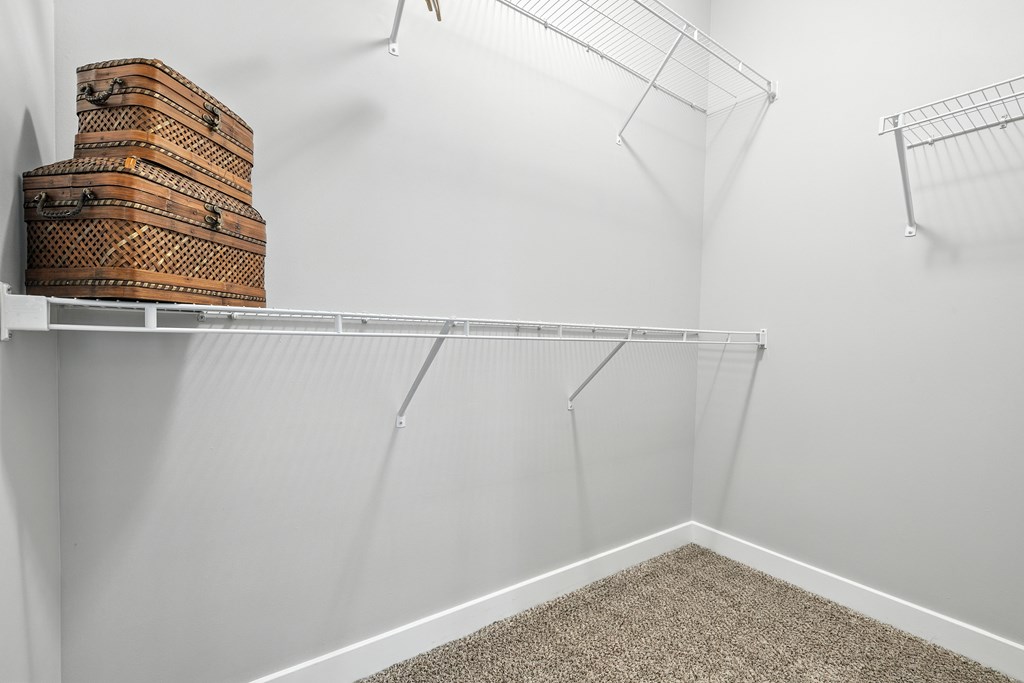 A white shelf with a few boxes on it.