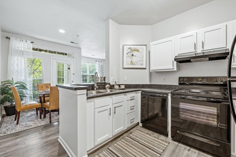 A modern kitchen with white cabinets and a large island.