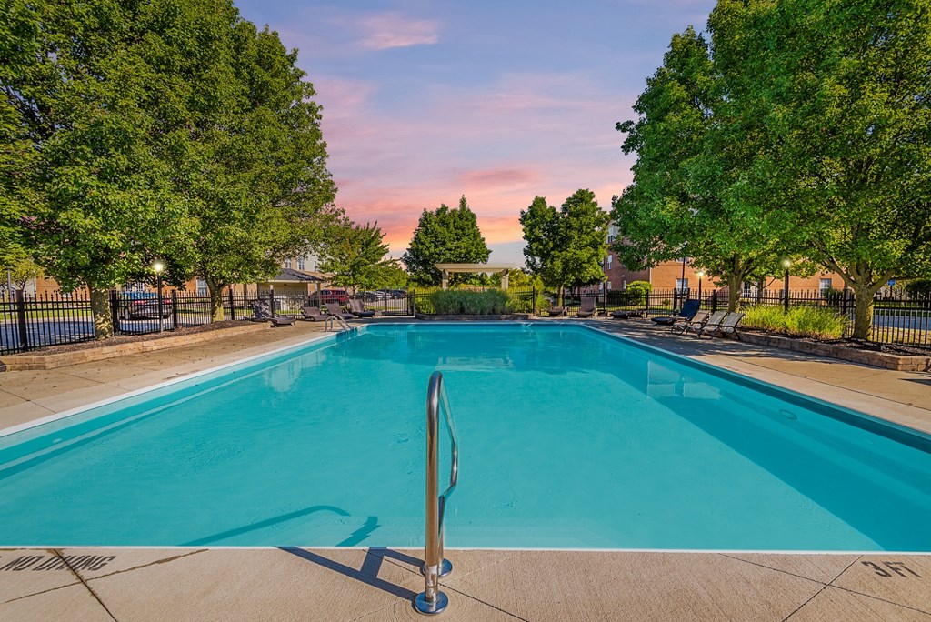 Apartments in Hilliard, OH, for Rent - Residences at Breckenridge - Pool Surrounded by Lounge Chairs and Lush Greenery
