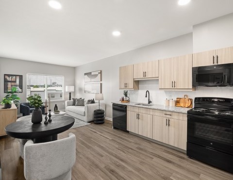 A modern kitchen with a black countertop and a dining table with chairs.