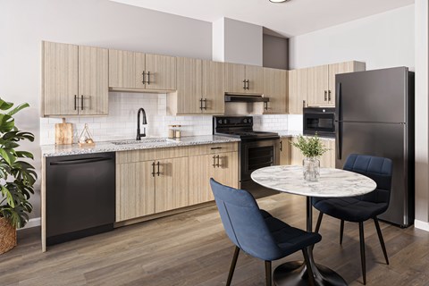 A modern kitchen with a dining table and chairs.