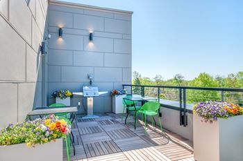 our apartments showcase a naturally well lit balcony with a grill