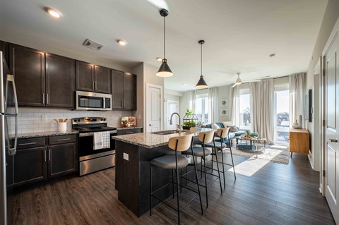 a kitchen with a large island and a table with chairs