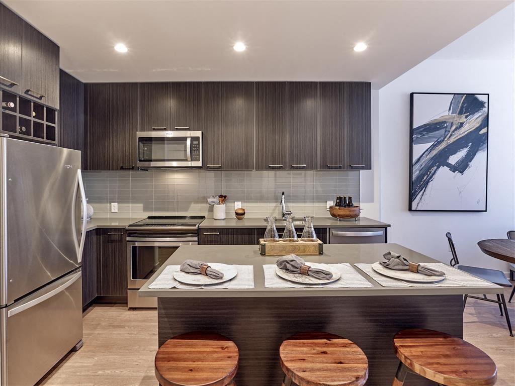 a kitchen with a counter top and a refrigerator