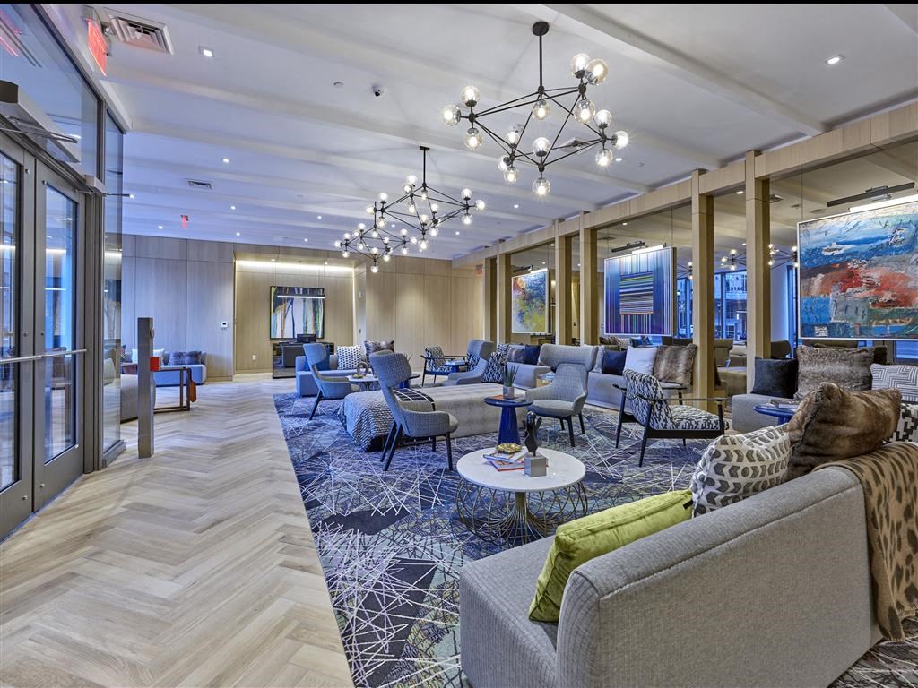 a lobby with couches and chairs and a chandelier