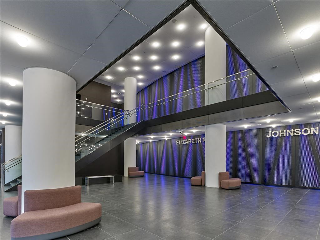 the lobby of a large building with purple curtains