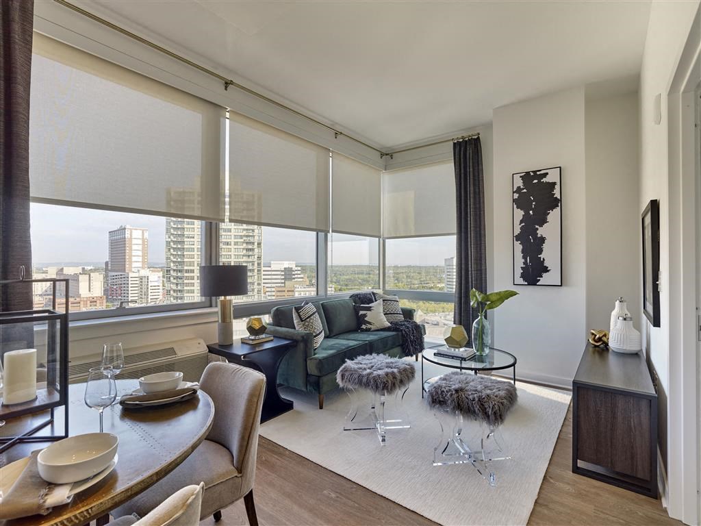 a living room with a view of the city and a table and chairs
