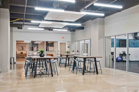 A modern office space with a dining area in the foreground.