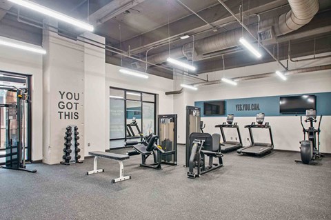A gym with a sign that says "You got this" on the wall.