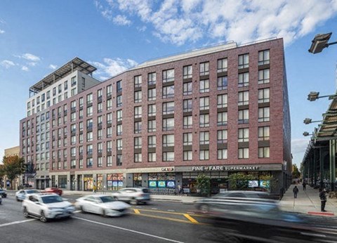a large brick building on the corner of a busy city street