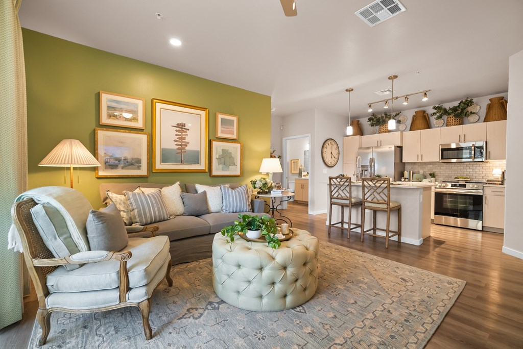 A living room with a green wall and a white couch.