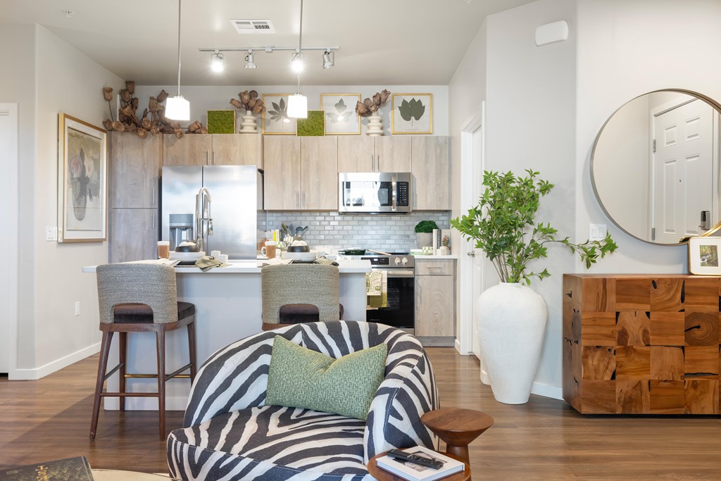 A modern kitchen with a zebra print chair in the foreground.