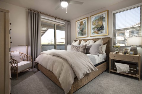A bedroom with a large bed and a ceiling fan.