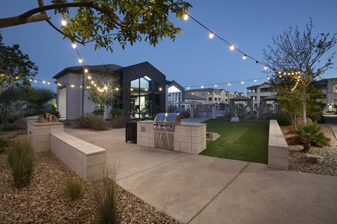 A modern house with a glass entrance and outdoor string lights.