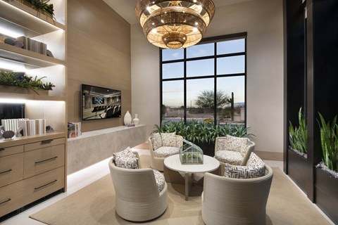 A modern living room with a large window, a sofa, a chair, and a table.