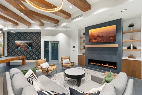 A modern living room with a fireplace and a painting on the wall.