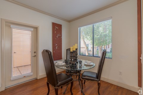 A dining room with a table and chairs.