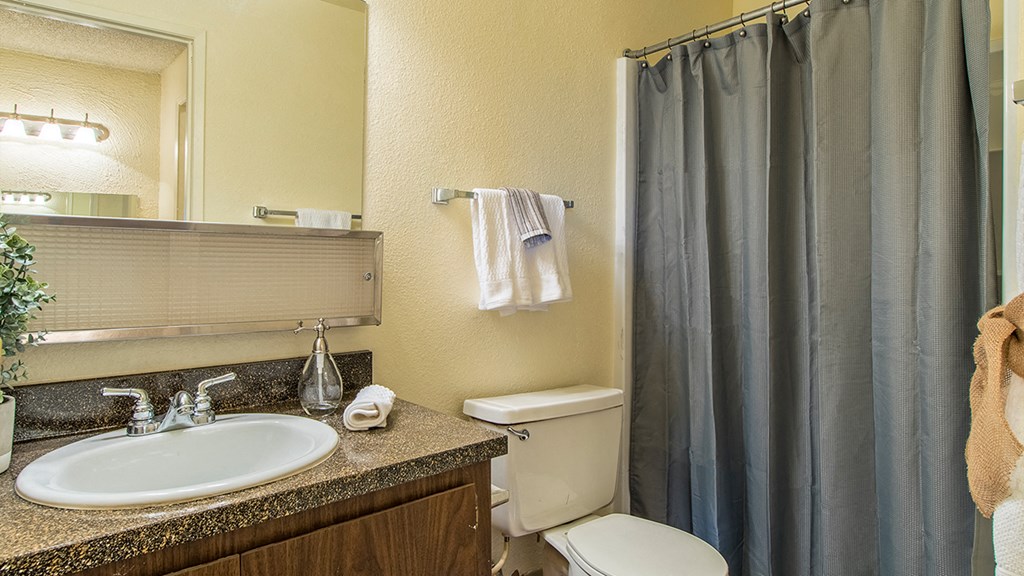 Cottonwood Creek bathroom with brown cabinetry.