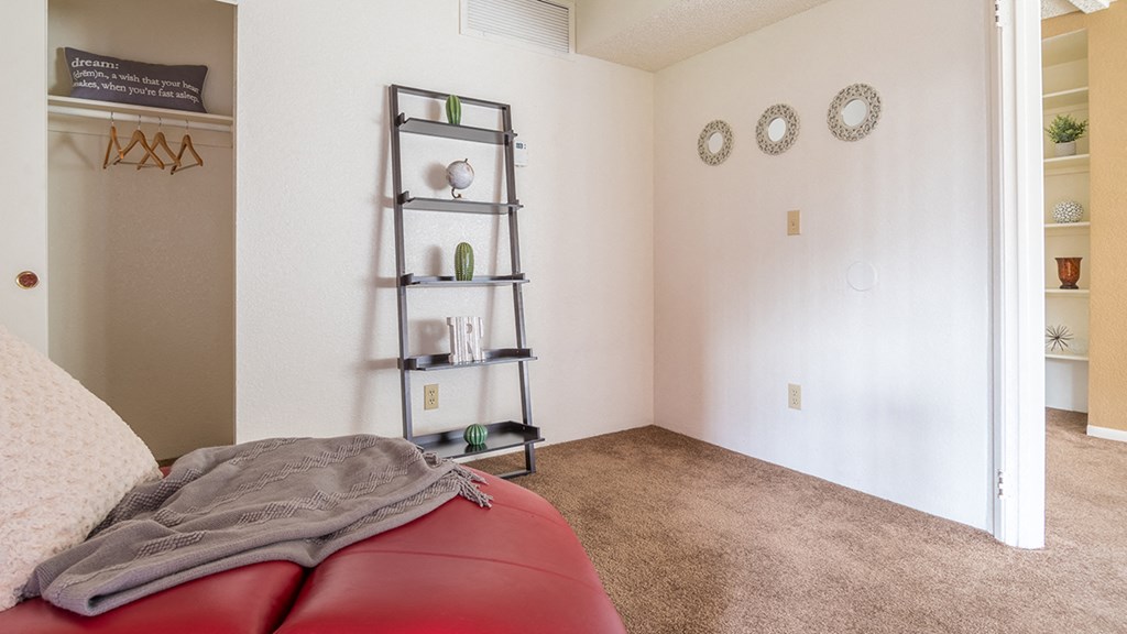 Ridgepointe bedroom with carpet flooring and glass doors with access to private balconies or patios