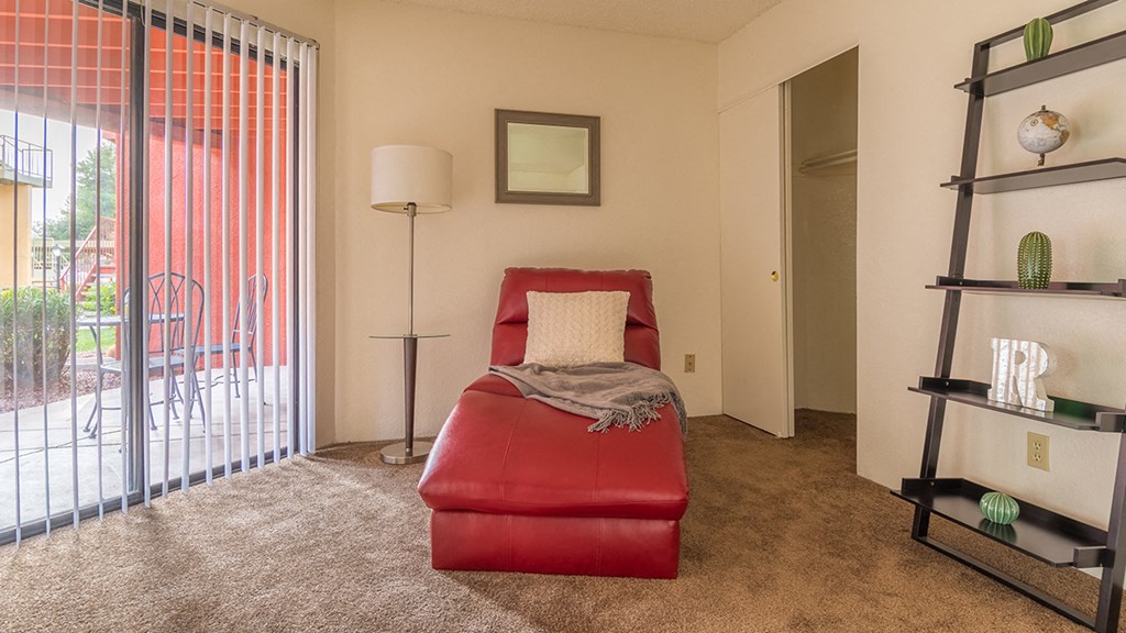 Ridgepointe bedroom with carpet flooring and glass doors with access to private balconies or patios