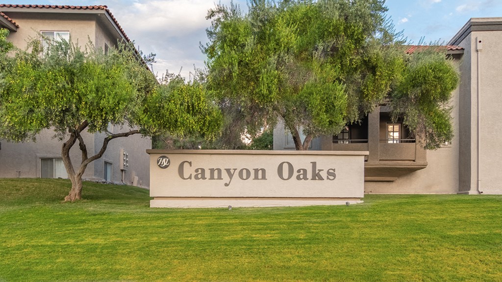 Canyon oaks community sign with lush landscape