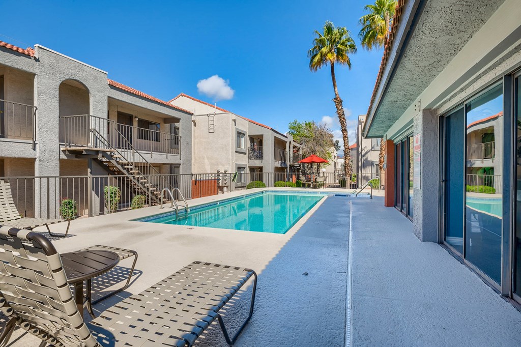 our apartments have a swimming pool and a patio with chairs