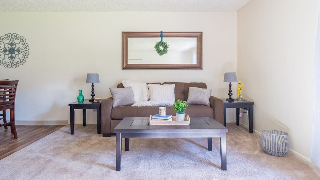 The Springs living room with carpet flooring and ceiling fans