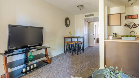 El Encanto spacious living room with a nice TV and carpet flooring
