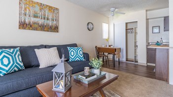 The Springs living room with carpet flooring and ceiling fans - Photo Gallery 5
