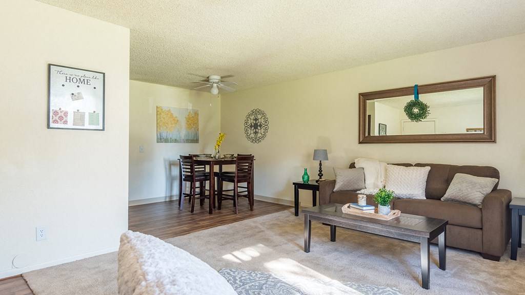 The Springs living room with carpet flooring and ceiling fans