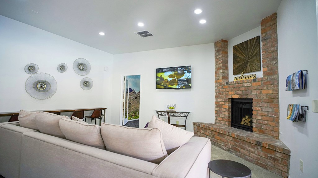 A living room with a fireplace and a couch.