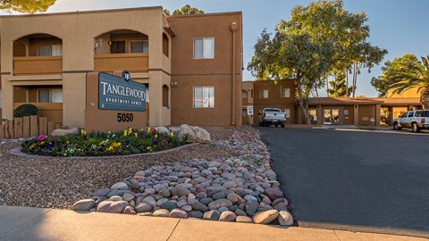 Tanglewood community sign with well kept entrance and flowers all around