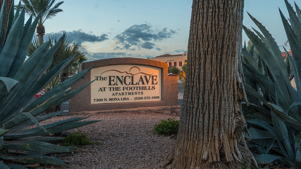 Enclave community sign near well kept entrance