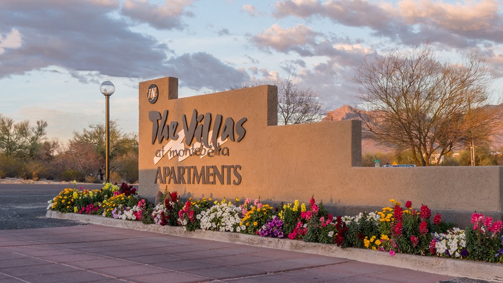 villas at Montebella community sign with pretty flowers planted around