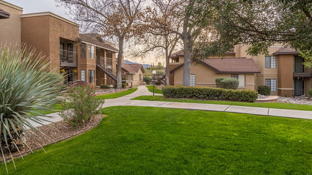 Arboretum view of apartments with lush landscape