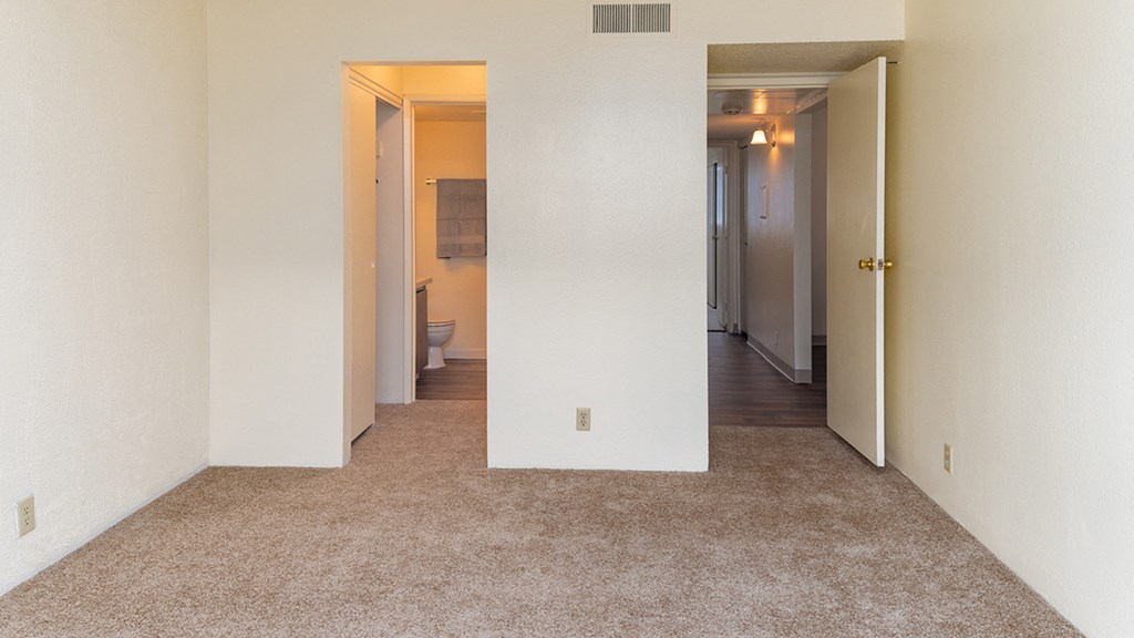 Cottonwood Creek master bedroom with a walk in closet and doorway.