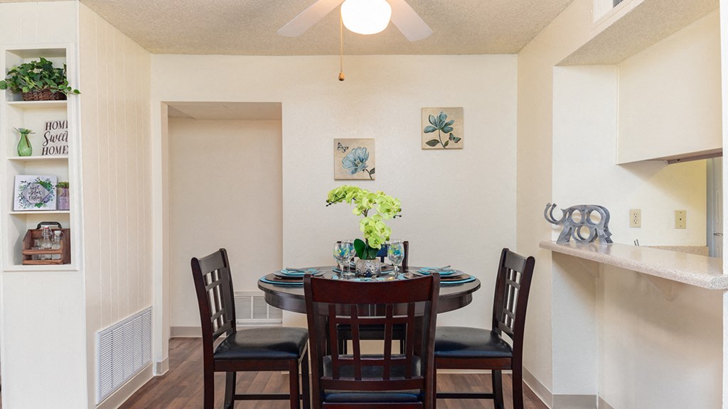 Cottonwood Creek dining room with cream colored walls and a dark brown dining table set.