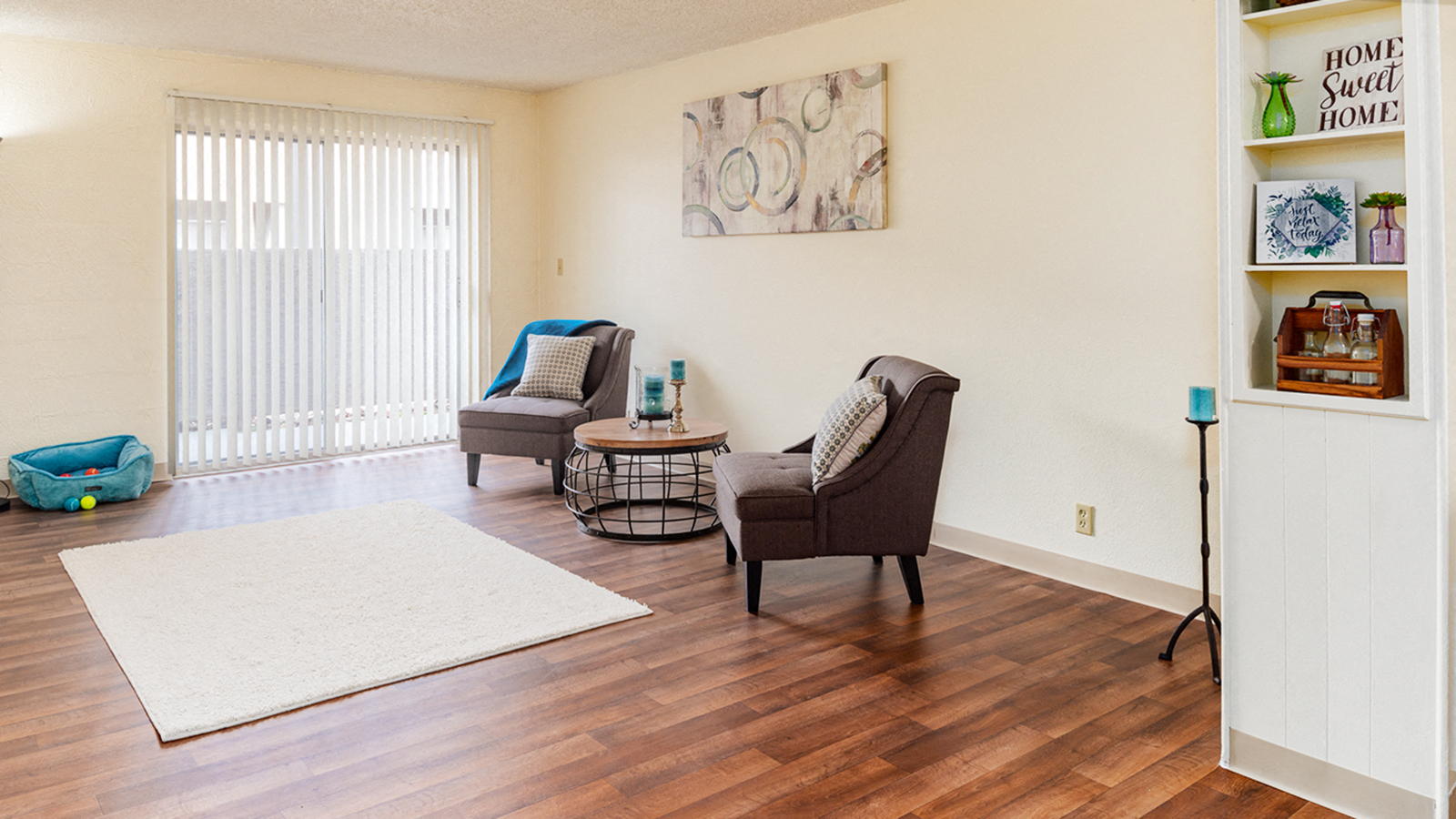 a living room with two chairs and a sliding glass door