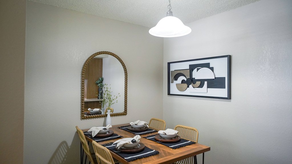 A dining table set with plates and napkins is ready for a meal.