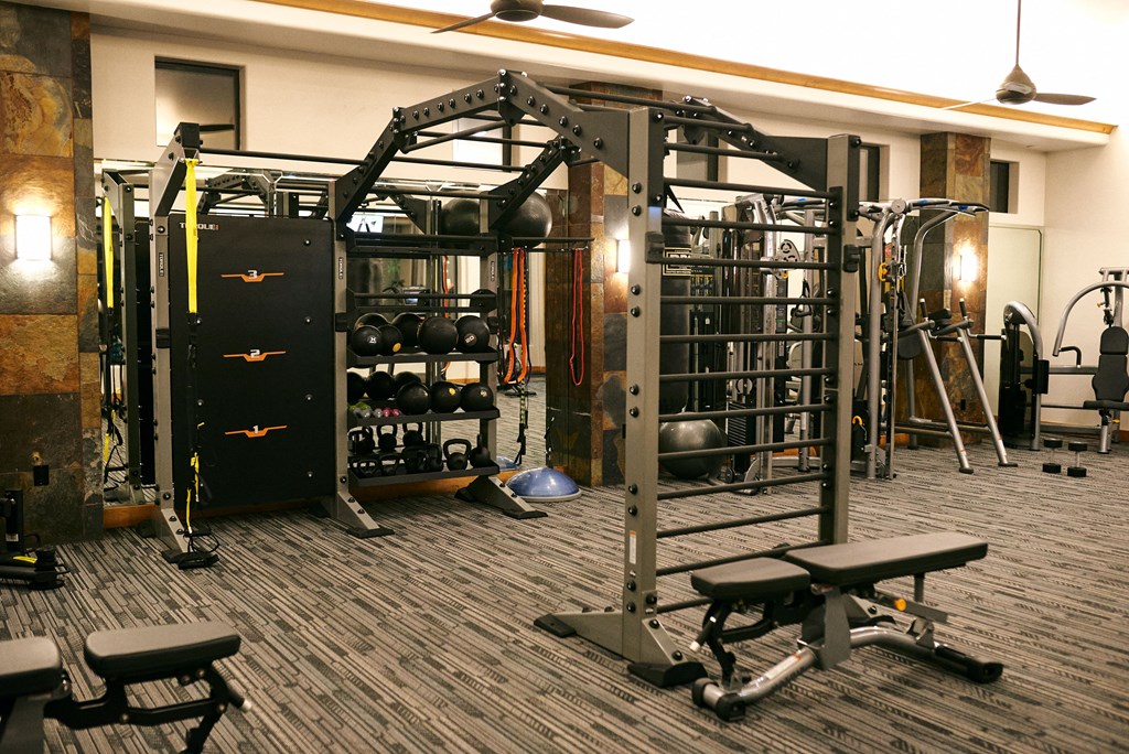 a gym with weights and equipment on the floor